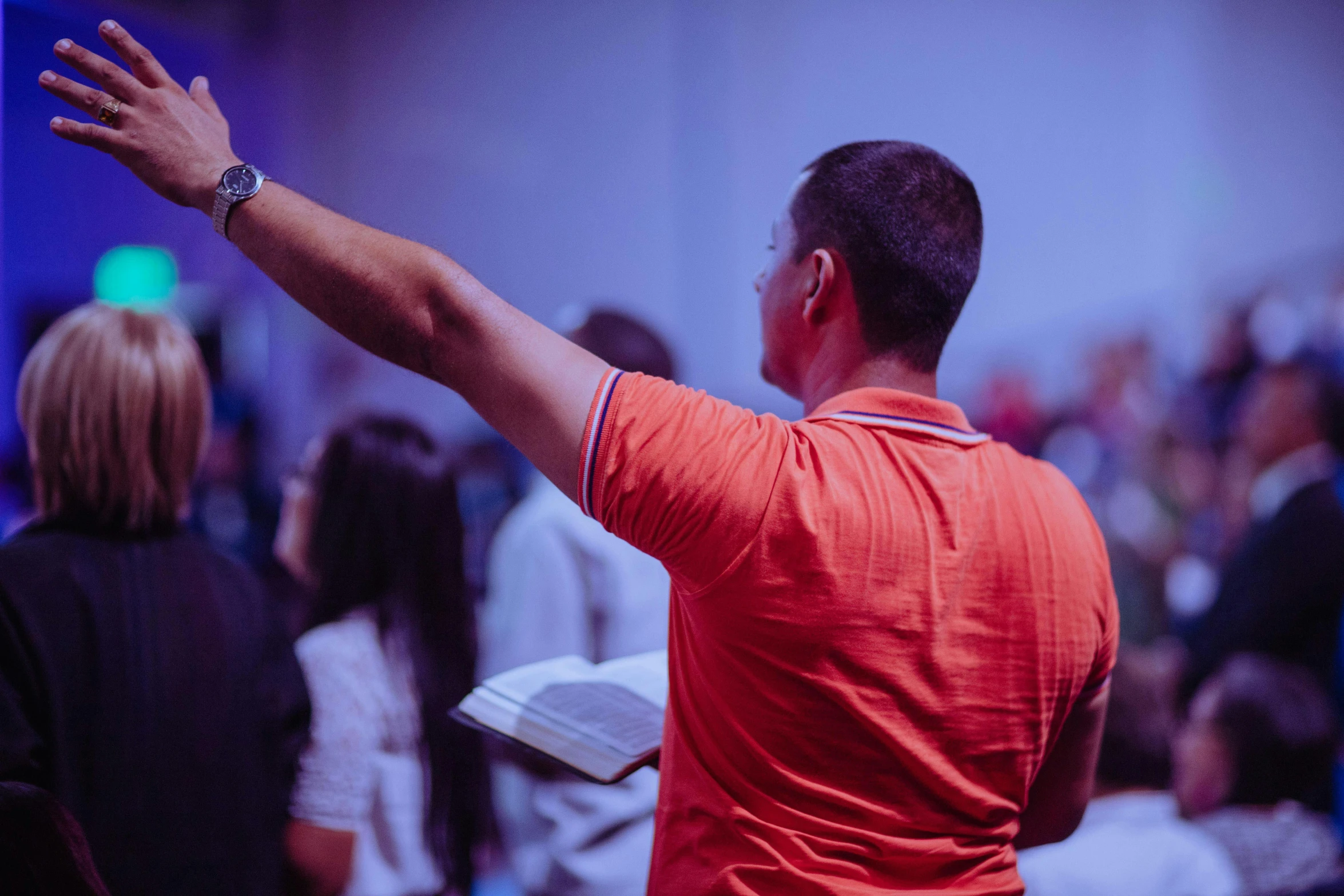 a man standing in front of a crowd of people, worship, pointing, profile image, andrew gonzalez