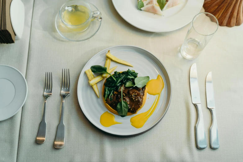 a close up of a plate of food on a table, pexels contest winner, renaissance, yellow, birdseye view, gourmet restaurant, lightly dressed