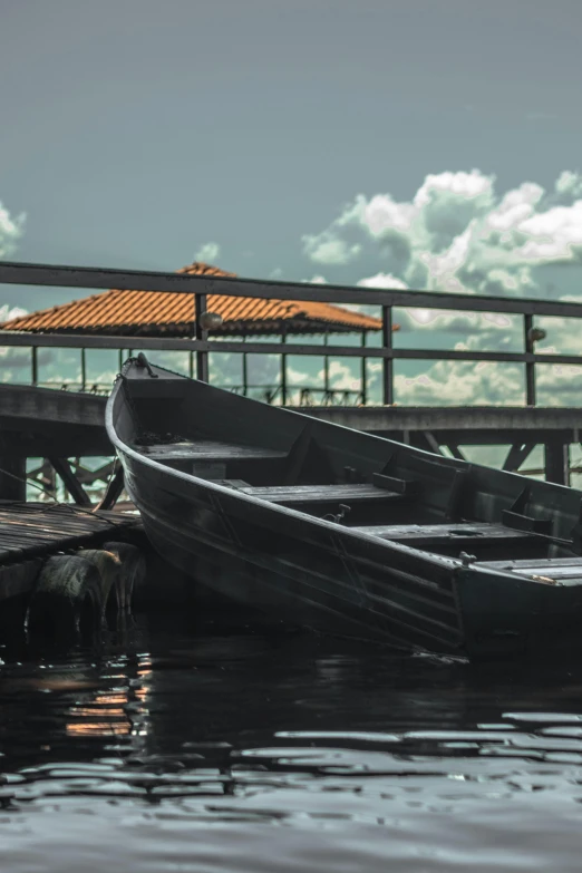 a couple of boats sitting on top of a body of water, sitting on a wooden dock, brazil, buildings covered in black tar, slide show