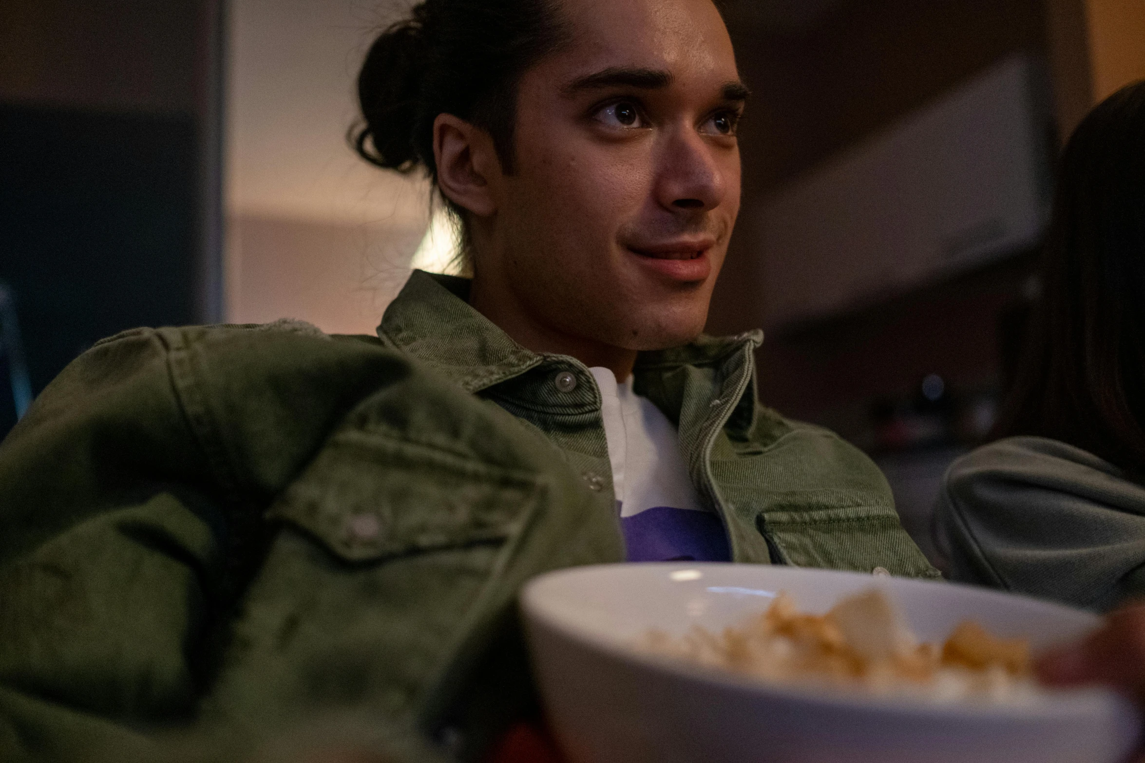 a man sitting at a table with a bowl of cereal, lights on, avan jogia angel, shot with sony alpha 1 camera, high-res