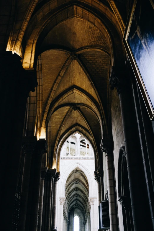 a couple of people that are standing in a building, by Theo Constanté, unsplash, romanesque, flying buttresses, dark hallways, underside, well contoured smooth fair walls