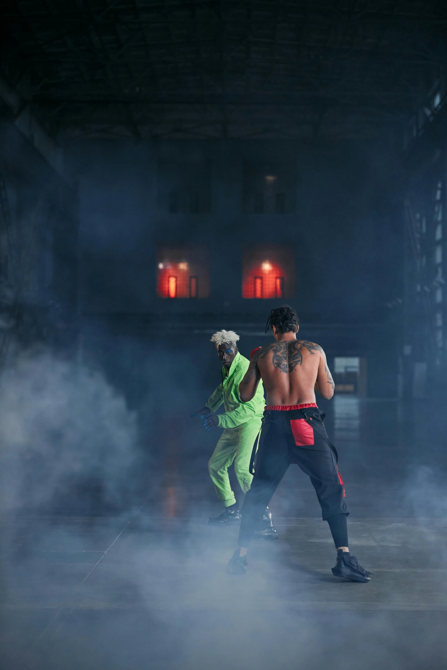 a couple of people that are standing in the smoke, an album cover, inspired by Mike Winkelmann, trending on pexels, ninjala, in a warehouse, boxing match, still from a music video