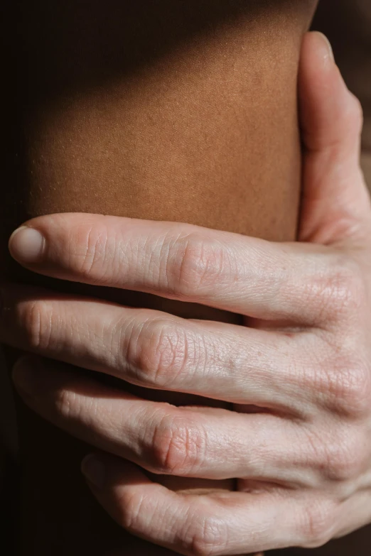 a close up of a person holding their stomach, by Nina Hamnett, knee, real-life skin, soft shade, holding hand