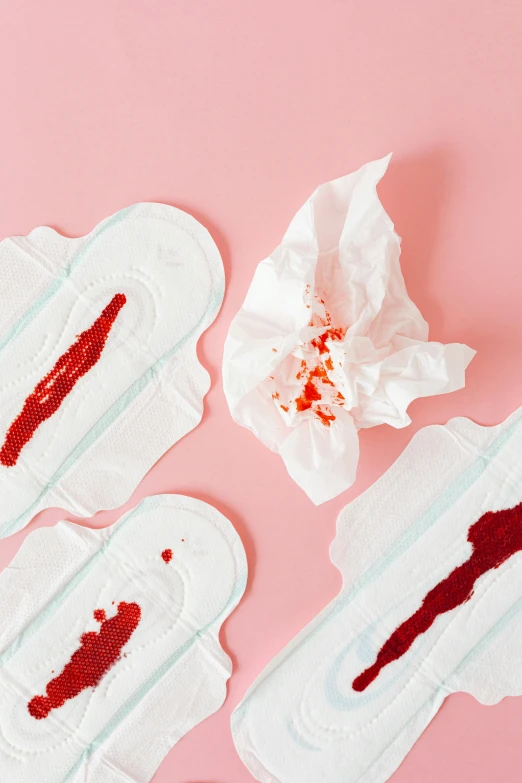 a bunch of tissues sitting on top of a pink surface, by Julia Pishtar, bloody knife, blood around the lips, product design shot, contracept