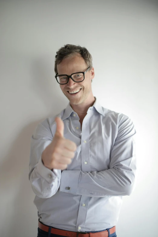 a man with glasses giving a thumbs up, by Simon Marmion, tall forehead, alex gray, profile image, satisfied pose