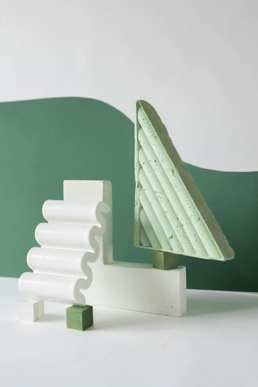 a white christmas tree sitting on top of a white table, an abstract sculpture, inspired by Isamu Noguchi, green hills, full product shot, soap, architectural section