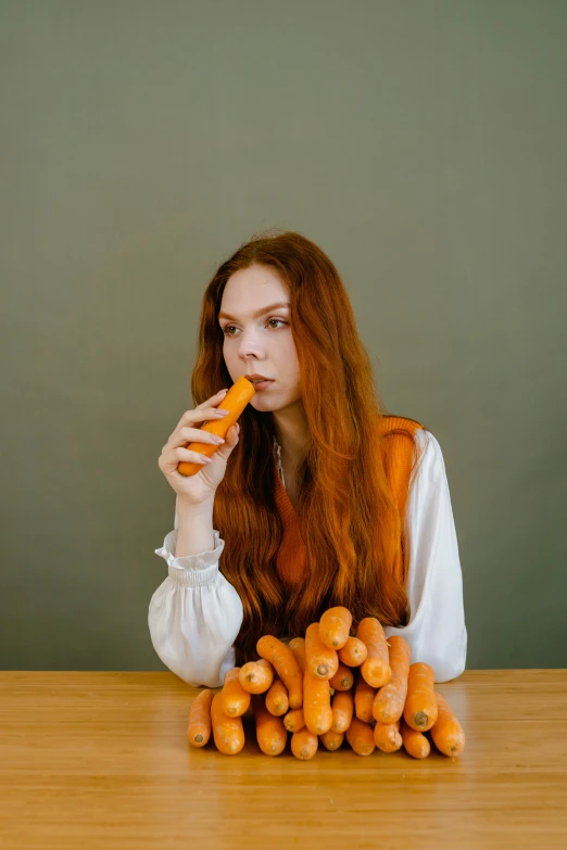 a woman sitting at a table with carrots in front of her, inspired by Sarah Lucas, unsplash, long ginger hair, hot dog, shot in the photo studio, 🍸🍋