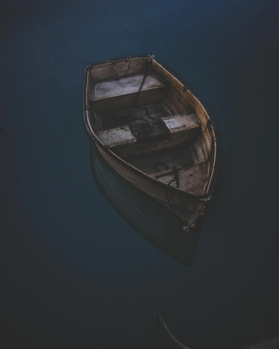 a small boat floating on top of a body of water, dark skin, sombre mood, scandinavian, multiple stories
