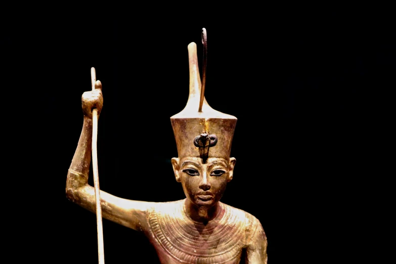 a statue of an egyptian man holding a staff, egyptian art, by Caroline Mytinger, pexels, with scepter and crown, kris kuksi, top lit, ifa deity