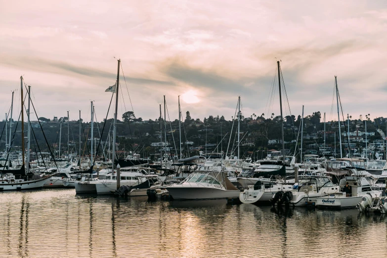 a harbor filled with lots of boats under a cloudy sky, pexels contest winner, australian tonalism, pink golden hour, a cozy, manly, soft morning light
