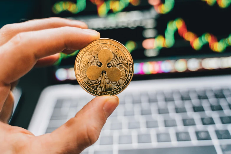 a person holding a bitcoin in front of a laptop, by Adam Rex, trending on unsplash, art nouveau, clover, in front of a round, ripple, thumbnail