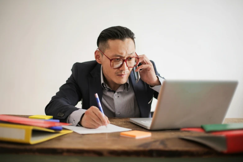 a man sitting at a desk in front of a laptop computer, pexels, asian origin, funny professional photo, te pae, have a call to action