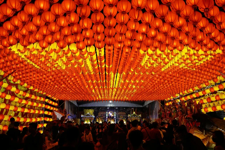 a room filled with lots of orange lanterns hanging from the ceiling, yellow dragon head festival, keng lye, lightshow, square