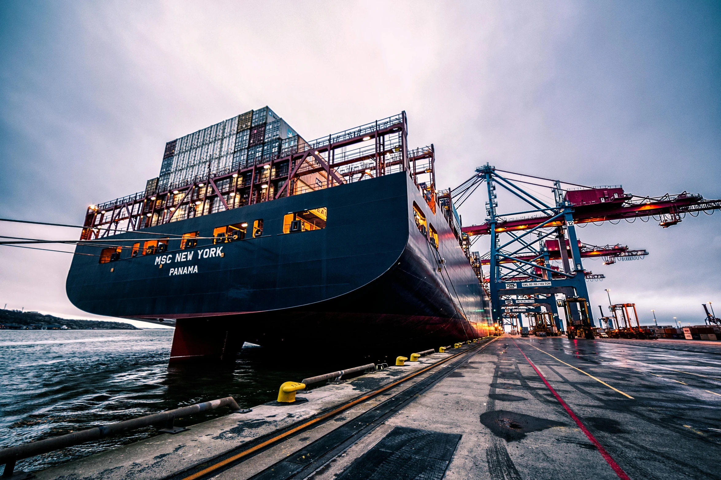 a large ship sitting on top of a body of water, pexels contest winner, inspect in inventory image, supply chain economics, ground level shot, dramtically lit