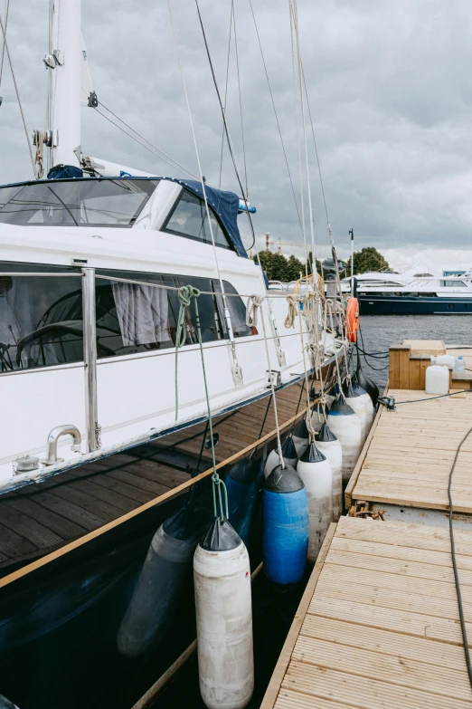 a boat docked at a dock on a cloudy day, a portrait, swanland, high resolution photo, extra detail, yolie leif