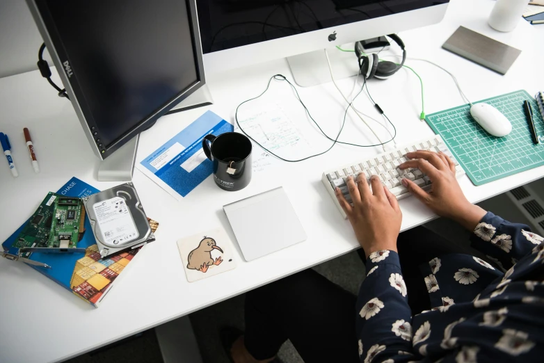 a person sitting at a desk typing on a keyboard, a cartoon, trending on unsplash, high angle shot, 9 9 designs, maintenance photo, computer mouse