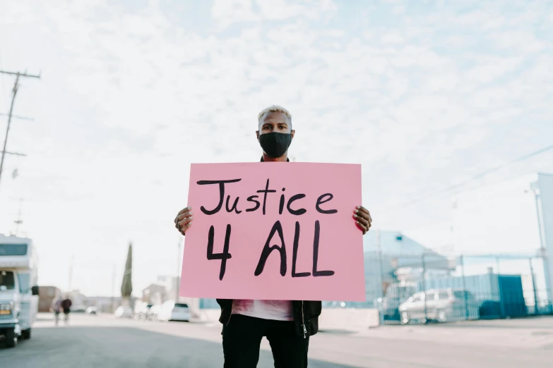 a man holding a sign that says justice 4 all, by Julia Pishtar, trending on pexels, renaissance, diverse, profile pic, pokimane, without text