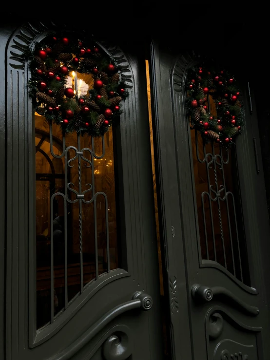 a couple of doors that are next to each other, by Jan Tengnagel, art nouveau, festive atmosphere, alessio albi, holiday season, black steel with red trim