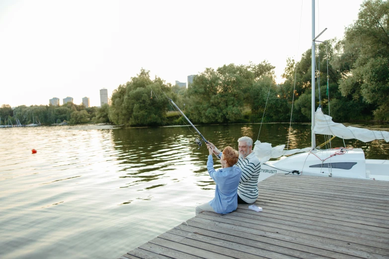 a man and a boy sitting on a dock fishing, by Peter Churcher, pexels contest winner, hurufiyya, melbourne, sail, where a large, hanging