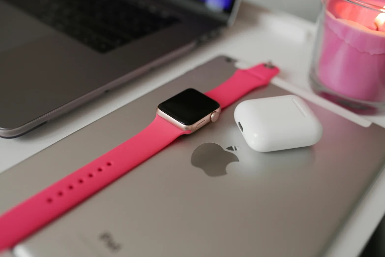 a laptop computer sitting on top of a desk next to a pink apple watch, pexels, square, hot pink, leaked image, up close picture