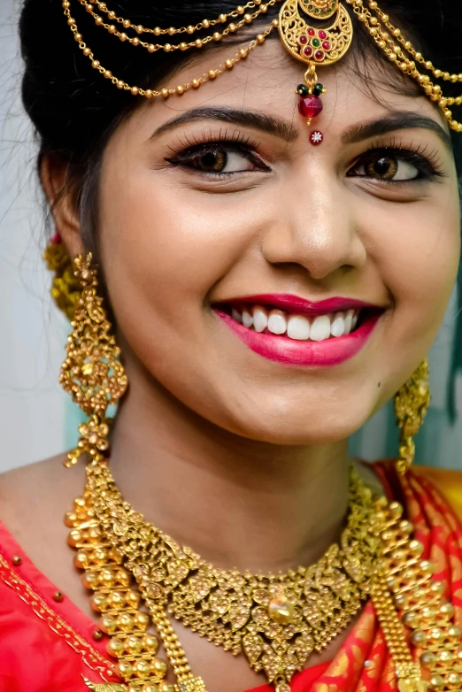 a close up of a woman wearing a necklace and earrings, a picture, uploaded, close up dslr studio photograph, sweet smile, square