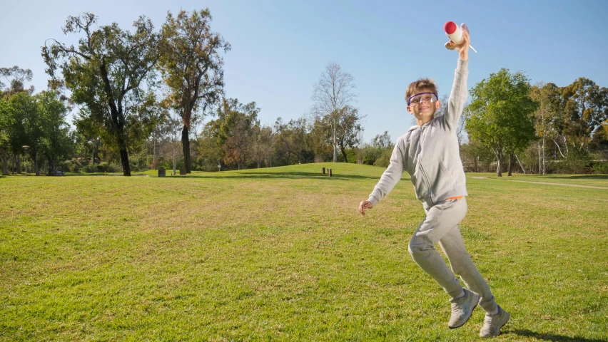 a man throwing a frisbee in a park, inspired by Mitchell Johnson, blippi, grey, dynamic action shot, ::