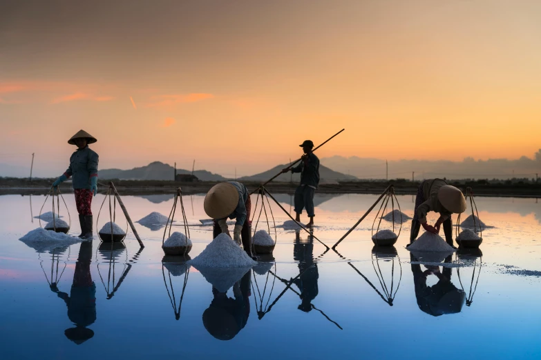 a group of people standing on top of a body of water, inspired by Steve McCurry, unsplash contest winner, process art, japanesse farmer, parasols, mining, at twilight