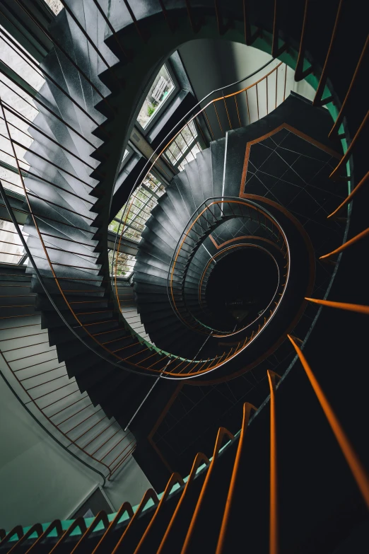 a spiral staircase leading to the top of a building, by Sebastian Spreng, unsplash contest winner, dark grey and orange colours, inside a science facility, shot on hasselblad, staggered depth)