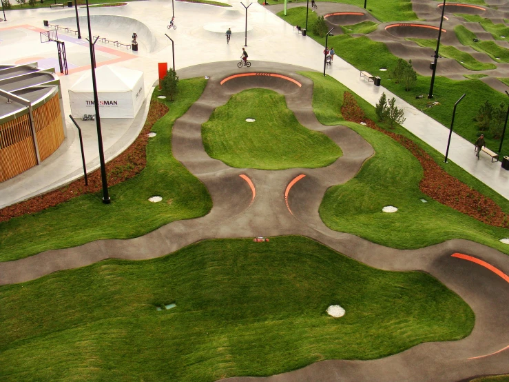 an aerial view of a skate park with many ramps, interactive art, orange grass, caulfield, contours, audrey plaza