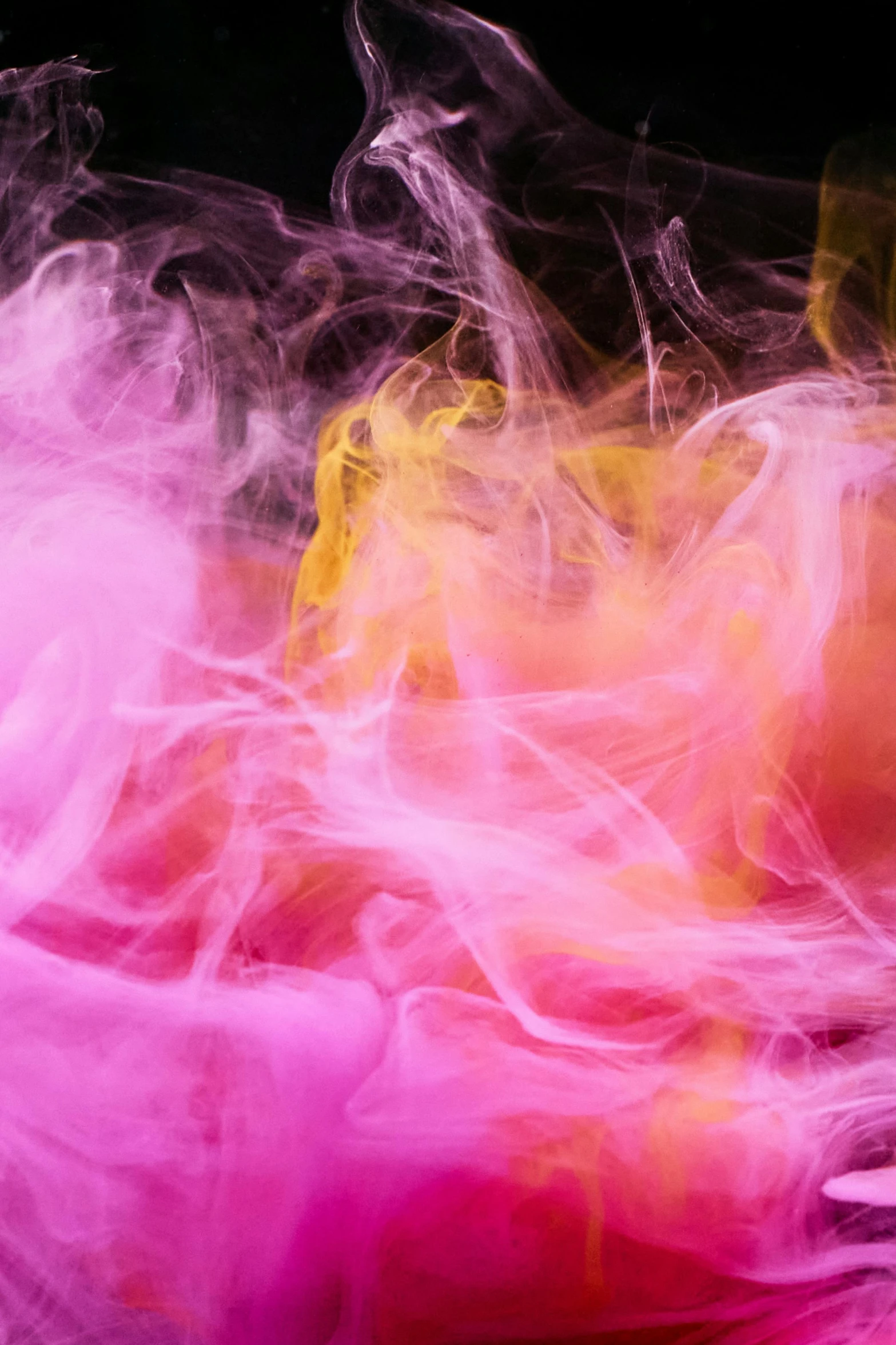 a close up of colored smoke on a black background, an abstract drawing, inspired by Kim Keever, pink and yellow, made of cotton candy, nick knight, pink and orange