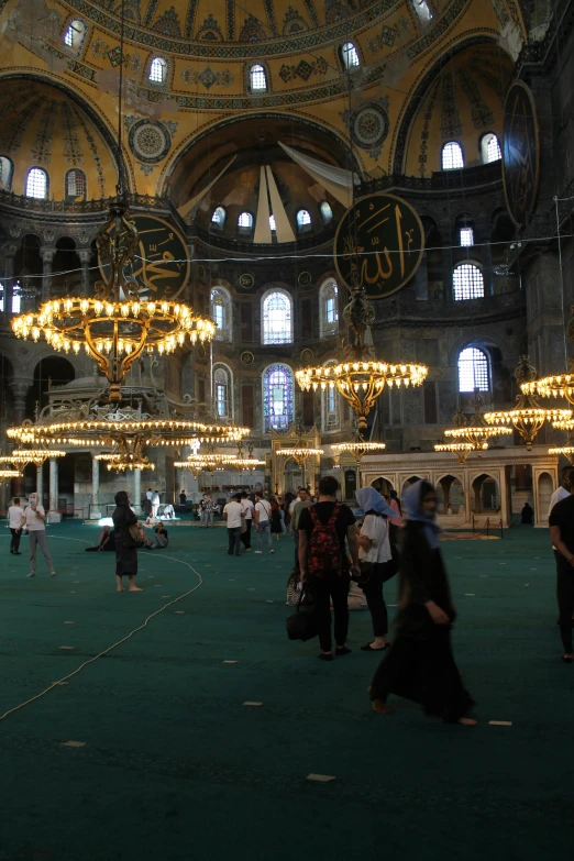 a group of people that are standing in a building, inspired by Altoon Sultan, hurufiyya, big chandelier, black domes and spires, full room view, green