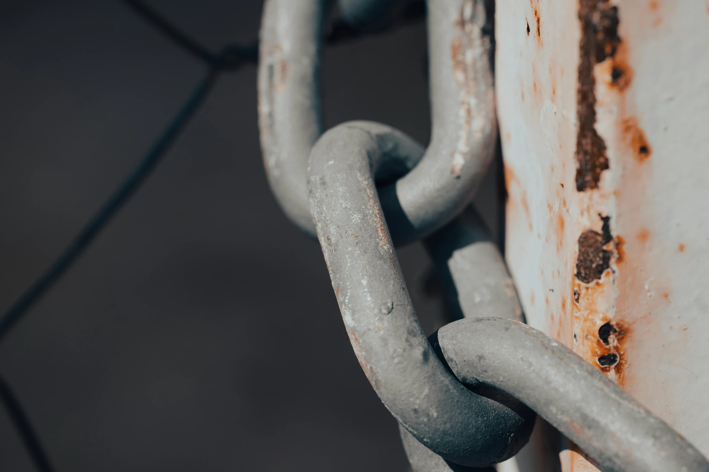 a close up of a chain on a fence, by Adam Marczyński, trending on pexels, rust background, on grey background, blockchain vault, high rendering