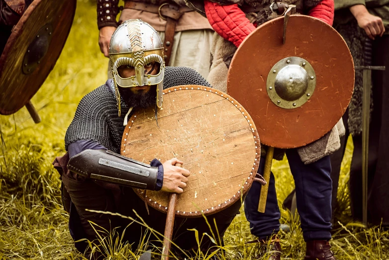 a man wearing a helmet and holding a shield, inspired by Þórarinn B. Þorláksson, pexels contest winner, instagram post, battle action, brown, english