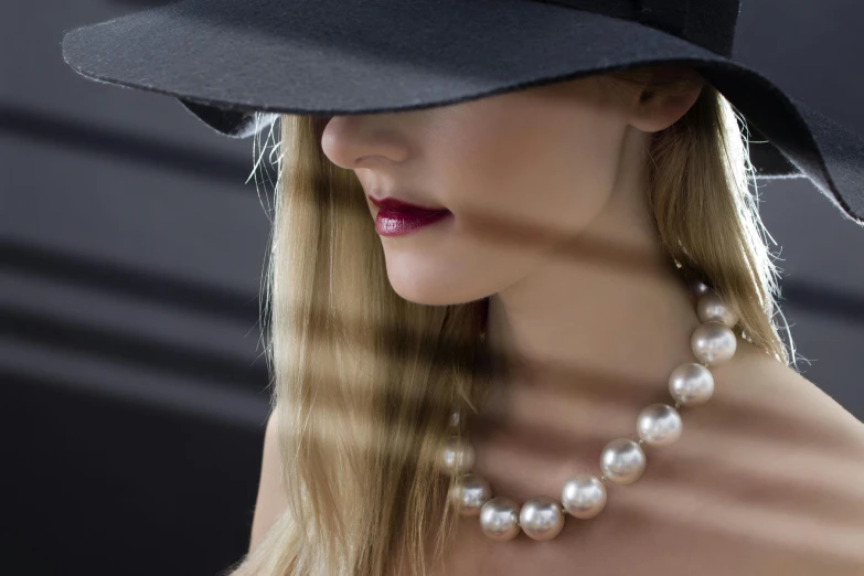 a woman wearing a black hat and pearl necklace, trending on pexels, photorealism, young blonde woman, fan favorite, jewelry lighting, pearlescent