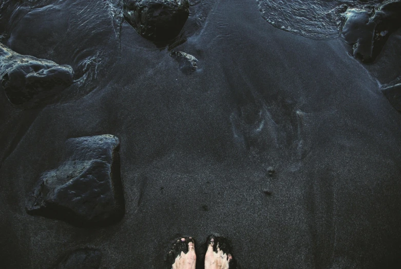 a person standing on a beach next to a body of water, by Matija Jama, pexels contest winner, black slime, barefeet, black floor, 15081959 21121991 01012000 4k