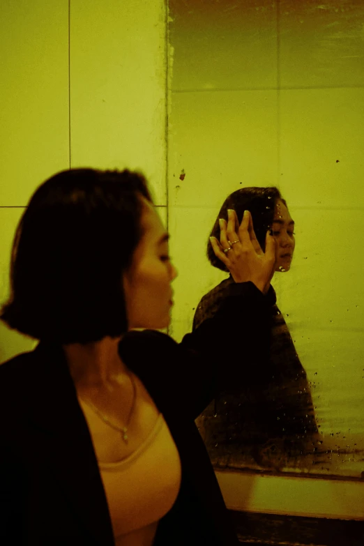 a woman that is standing in front of a mirror, inspired by Nan Goldin, unsplash, conceptual art, asian women, yellow and black, movie still of a tired, ( ( theatrical ) )