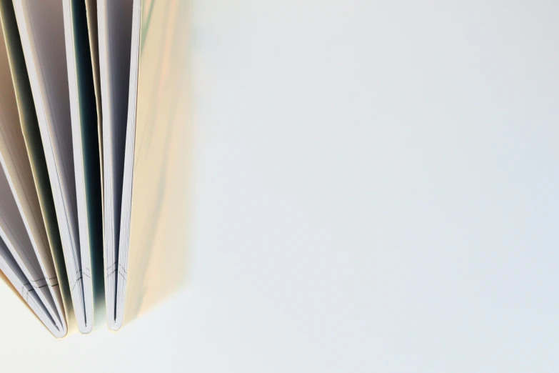 an open book sitting on top of a table, white space, background image, colour photograph, seen from below