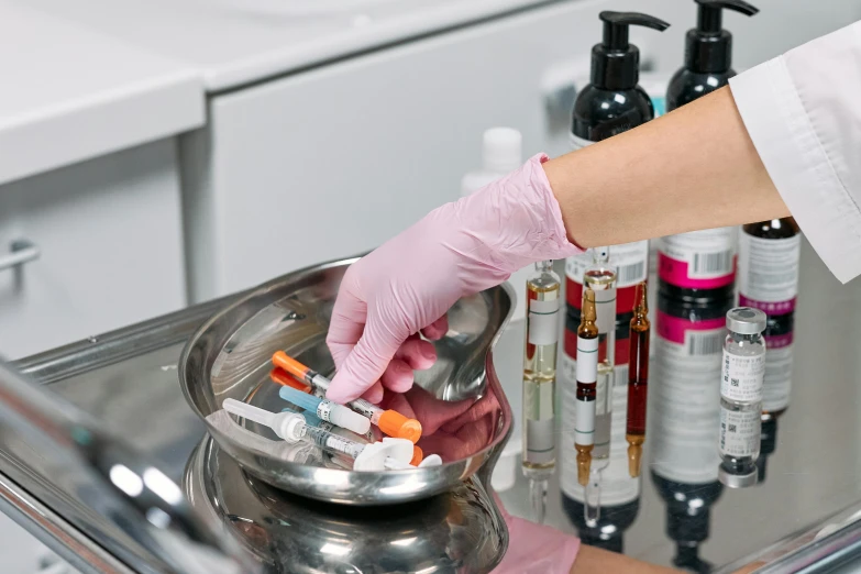 a close up of a person putting pills in a bowl, a hyperrealistic painting, by Julia Pishtar, shutterstock, smoking vessels, on an operating table, clean medical environment, wearing gloves