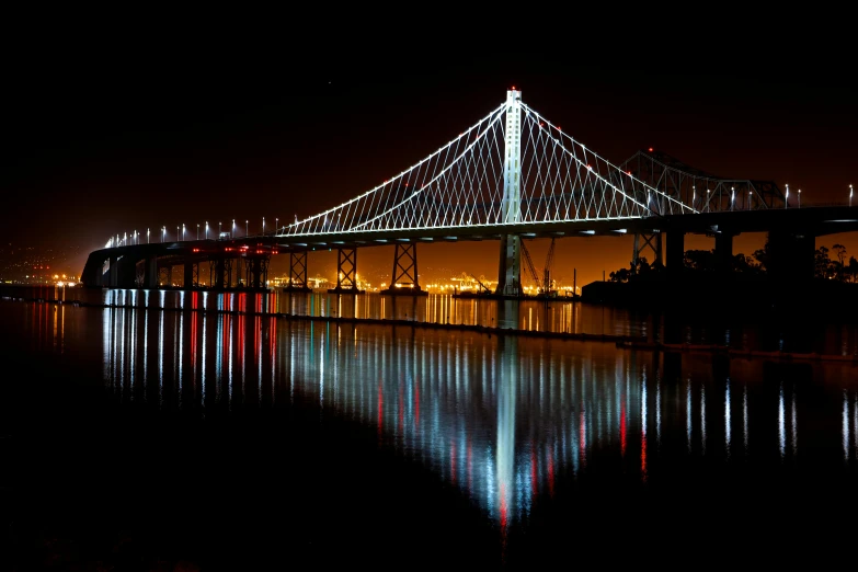 a bridge over a body of water at night, a hologram, by Tom Bonson, flickr, bay area, where a large, post processed, with a long