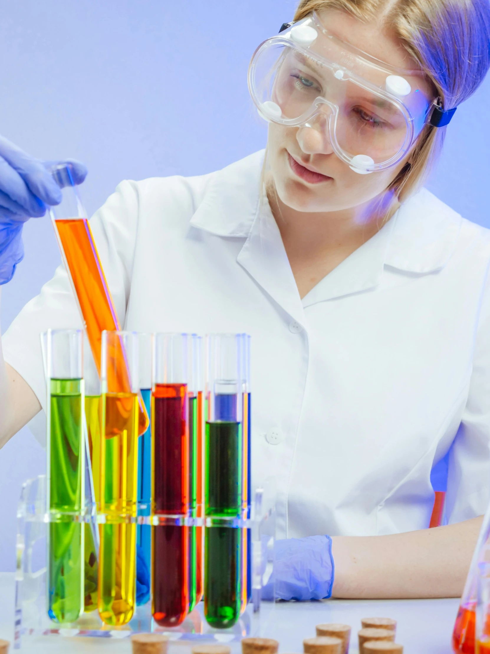 a woman in a lab coat and goggles working in a laboratory, shutterstock, analytical art, rainbow liquids, gif, girl wearing uniform, orange and turquoise and purple