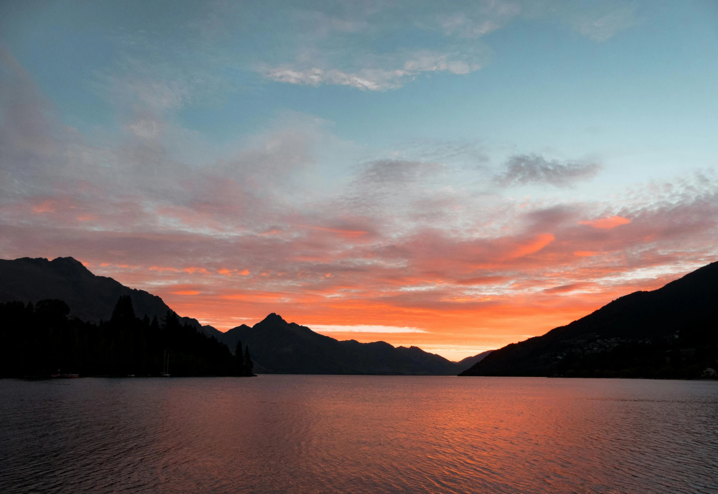 a large body of water with mountains in the background, by Sophie Pemberton, pexels contest winner, hurufiyya, red sunset, lake blue, elegant, where a large