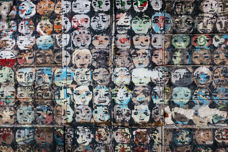 a wall with many different faces painted on it, a mosaic, by Micha Klein, unsplash, 1 6 x 1 6, grungy, zezhou chen, highresolution