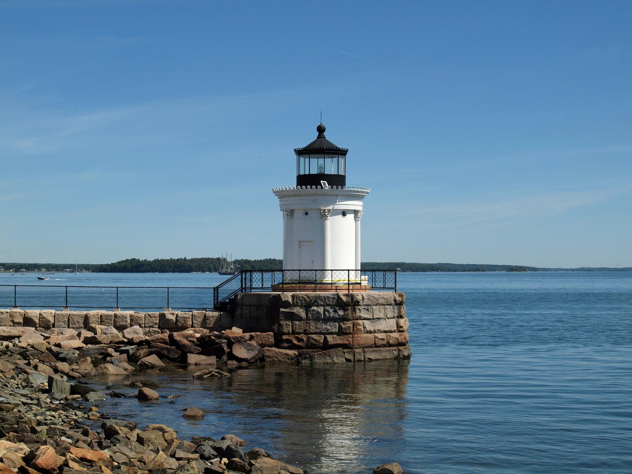 a lighthouse in the middle of a body of water, light blue water, preserved historical, vtmb, outdoor photo