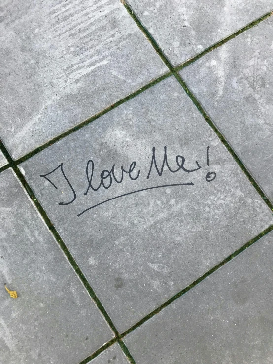 a sidewalk with the words i love me written on it, an album cover, by Tracey Emin, instagram, concrete art, tile, thumbnail, low detail, promo image