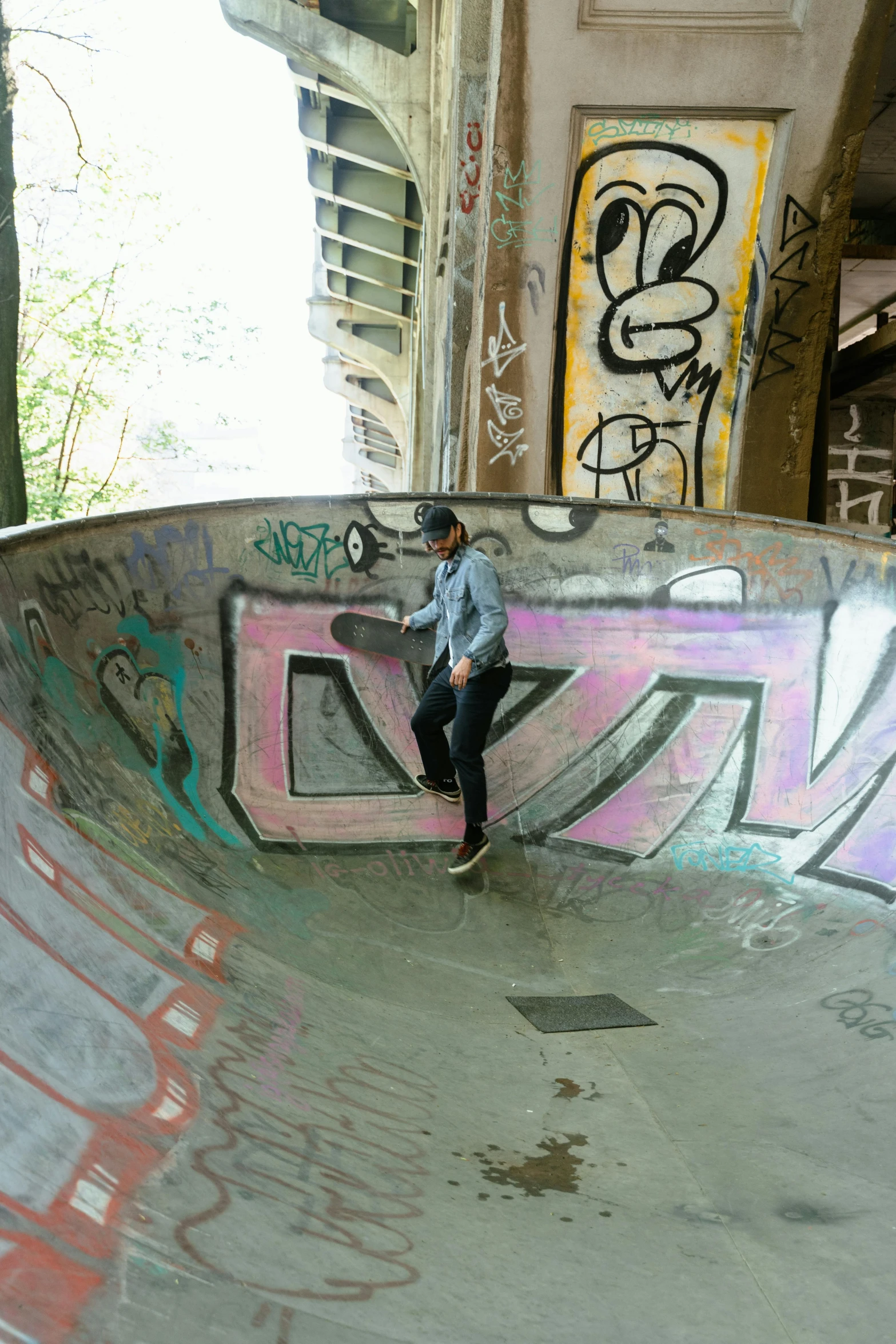 a man riding a skateboard up the side of a ramp, a picture, graffiti, in the middle of round ruins, berlin park, bowl, curves!!