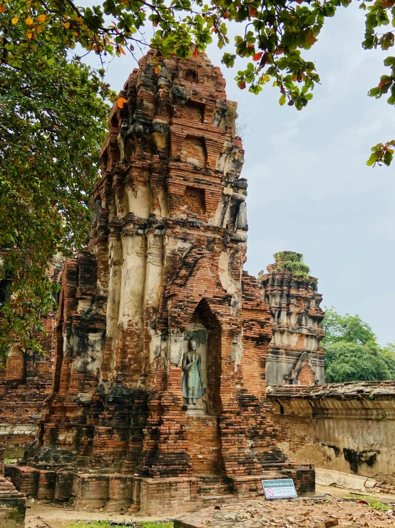 a large brick structure sitting in the middle of a field, a statue, unsplash contest winner, thai, ornate city ruins, background image, high resolution photo