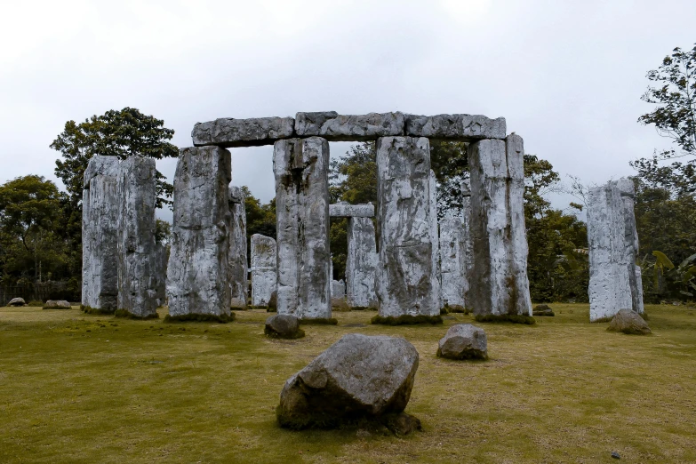 stonehenge on a cloudy day with trees in the background, a marble sculpture, by Jessie Algie, pexels contest winner, okinawa japan, thumbnail, indigo, a wooden