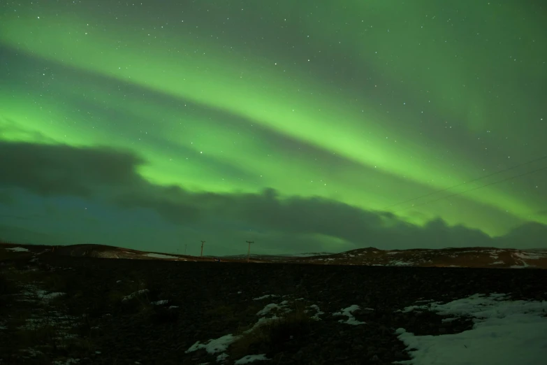 the northern lights shine brightly in the sky, an album cover, pexels contest winner, hurufiyya, green hills, black, electrical signals, luminist polar landscape