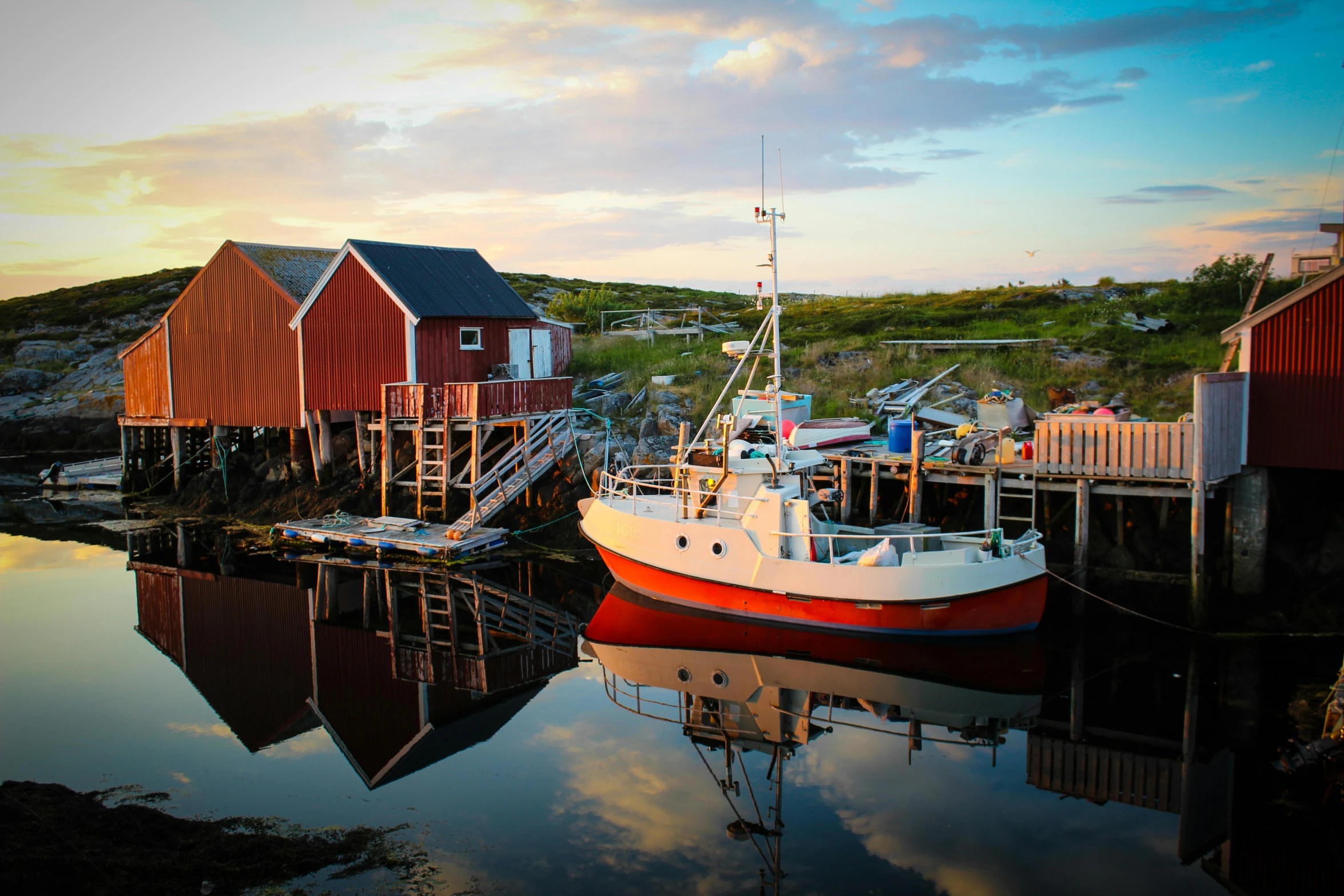 a boat that is sitting in the water, by Jesper Knudsen, pexels contest winner, hurufiyya, small port village, dramatic reddish light, beautiful sunny day, farming