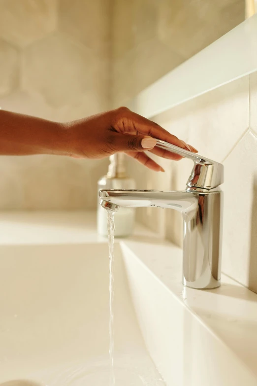 a woman is washing her hands under a faucet, inspired by Henry O. Tanner, smooth streamline, first light, thumbnail, cascade